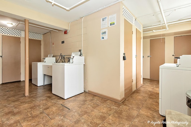 shared laundry area featuring washing machine and dryer