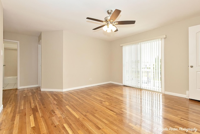 empty room featuring baseboards, ceiling fan, and light wood-style flooring