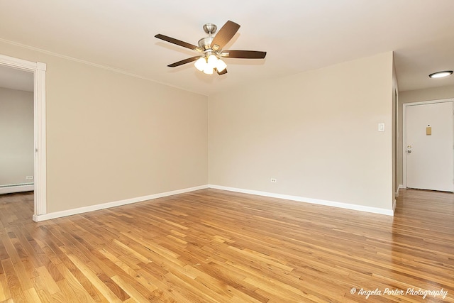 spare room featuring baseboards, a ceiling fan, and light wood-type flooring