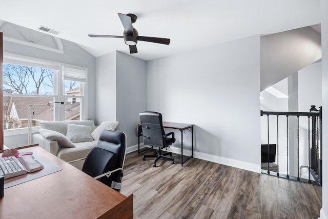 office space with wood finished floors, visible vents, a ceiling fan, and baseboards
