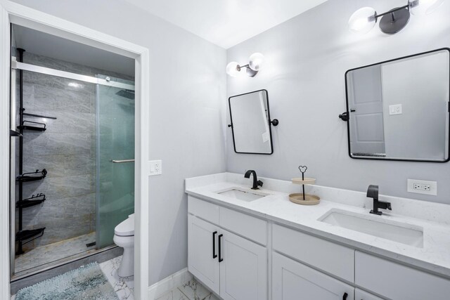 full bathroom with a shower stall, marble finish floor, toilet, and a sink