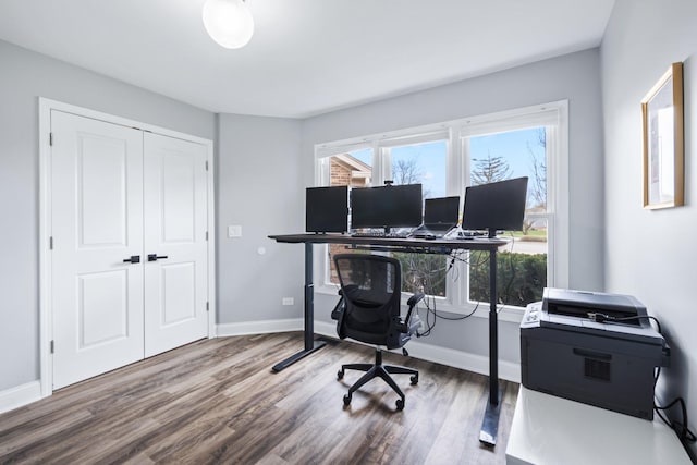 office space featuring baseboards and wood finished floors