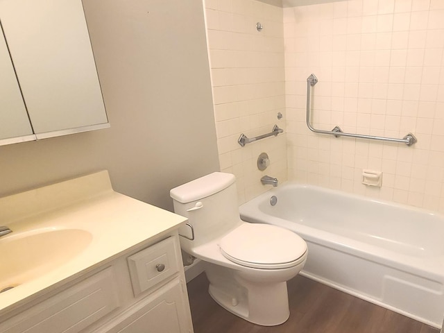 bathroom with toilet, shower / tub combination, wood finished floors, and vanity