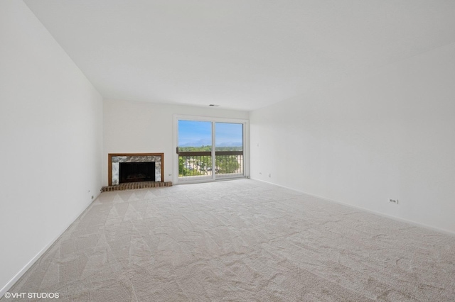 1250 Rudolph Rd Unit 5B, Northbrook, IL 60062 - unfurnished living room featuring carpet, a fireplace with raised hearth, and baseboards