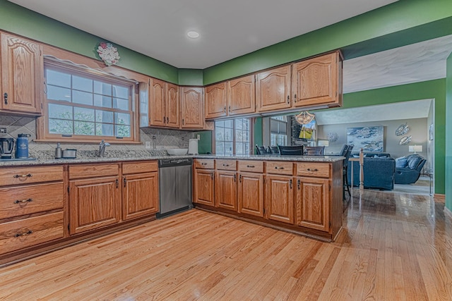39935 N Prairie View Dr, Wadsworth, IL 60083 - kitchen with dishwasher, light wood finished floors, brown cabinetry, light stone counters, and tasteful backsplash