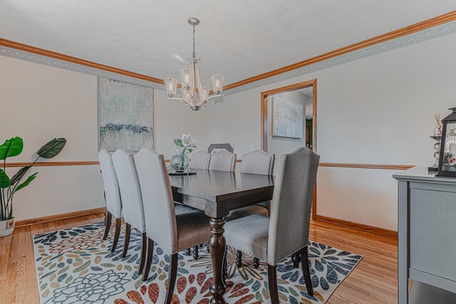 39935 N Prairie View Dr, Wadsworth, IL 60083 - dining area featuring a chandelier, wood finished floors, crown molding, and baseboards