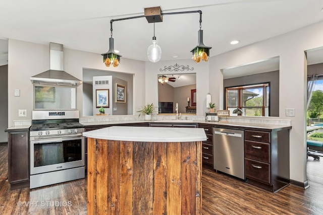 62 Foxhurst Ln, Newark, IL 60541 - kitchen with stainless steel appliances, wall chimney exhaust hood, light countertops, dark wood-style floors, and recessed lighting