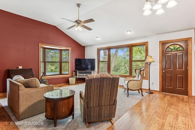 62 Foxhurst Ln, Newark, IL 60541 - living area with lofted ceiling, plenty of natural light, ceiling fan, wood finished floors, and a chandelier