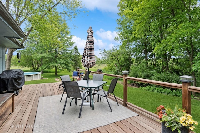 62 Foxhurst Ln, Newark, IL 60541 - wooden terrace with grilling area, outdoor dining space, an outdoor pool, a yard, and view of scattered trees