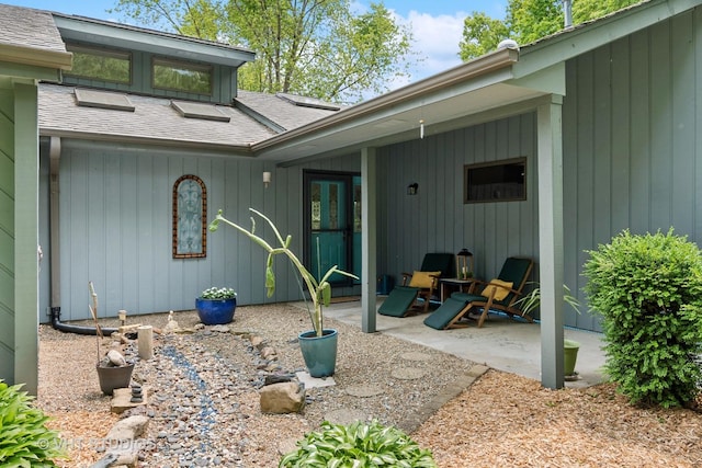 62 Foxhurst Ln, Newark, IL 60541 - doorway to property featuring roof with shingles and a patio area