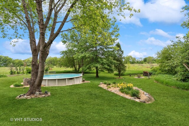 62 Foxhurst Ln, Newark, IL 60541 - view of green lawn featuring an outdoor pool