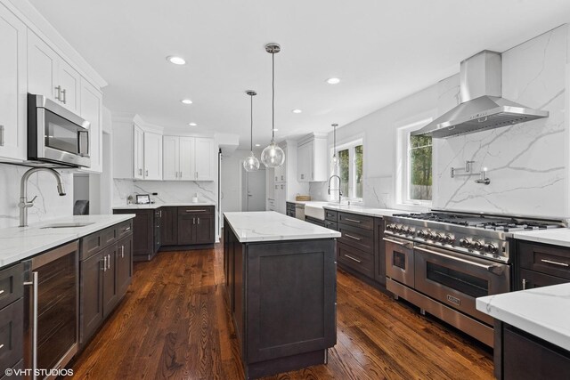 16 W Birchwood Ave, Hinsdale, IL 60521 - kitchen featuring stainless steel appliances, wall chimney range hood, wine cooler, dark brown cabinetry, and recessed lighting