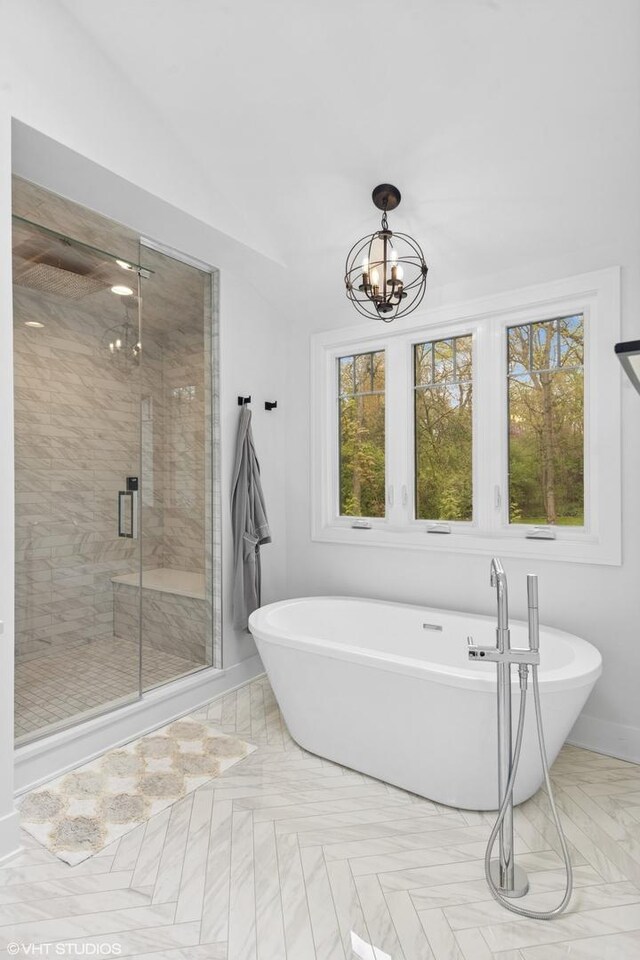 16 W Birchwood Ave, Hinsdale, IL 60521 - full bathroom featuring a chandelier, a shower stall, a freestanding tub, and baseboards