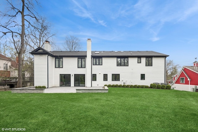16 W Birchwood Ave, Hinsdale, IL 60521 - back of property with a patio, a yard, and a chimney