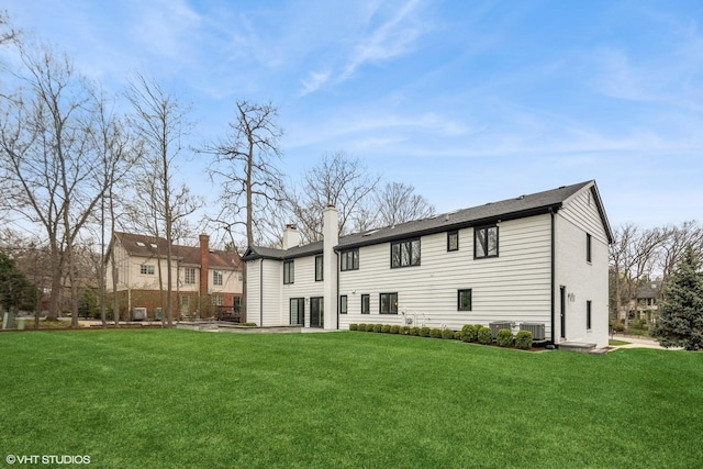16 W Birchwood Ave, Hinsdale, IL 60521 - rear view of property featuring cooling unit, a lawn, and a chimney