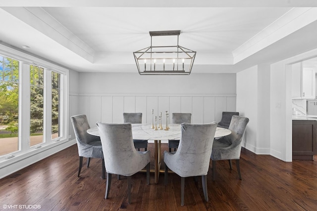 16 W Birchwood Ave, Hinsdale, IL 60521 - dining space with a tray ceiling, dark wood-style floors, a chandelier, and a wainscoted wall