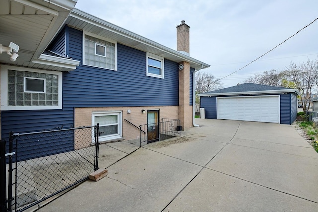 8856 N Merrill St, Niles, IL 60714 - back of property featuring a chimney, brick siding, a garage, and an outbuilding