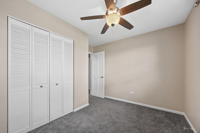 unfurnished bedroom featuring a closet, carpet flooring, a ceiling fan, and baseboards
