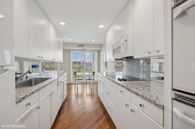 1220 Rudolph Rd Unit 5F, Northbrook, IL 60062 - kitchen featuring a sink, black electric stovetop, oven, dark wood-type flooring, and white microwave
