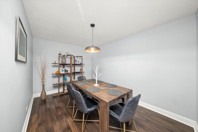 dining room featuring dark wood-style floors and baseboards