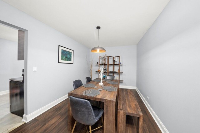 dining area featuring wood finished floors and baseboards