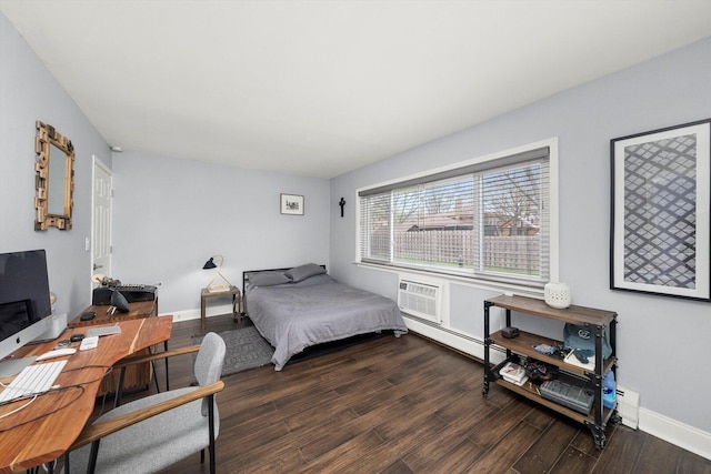 bedroom with baseboards, baseboard heating, wood finished floors, and a wall unit AC