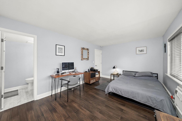 bedroom with baseboards and wood finished floors