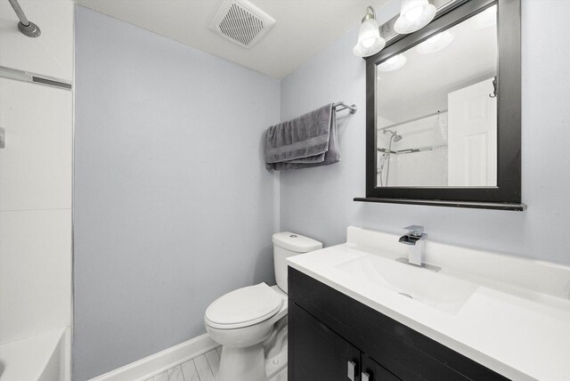 full bath with marble finish floor, toilet, vanity, baseboards, and visible vents