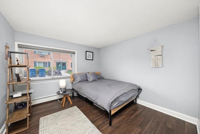 bedroom featuring wood finished floors and baseboards