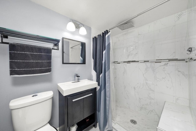 bathroom with toilet, a stall shower, and vanity