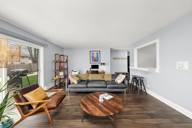 living room featuring baseboards and wood finished floors