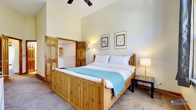 bedroom featuring carpet floors, a high ceiling, baseboards, and a ceiling fan