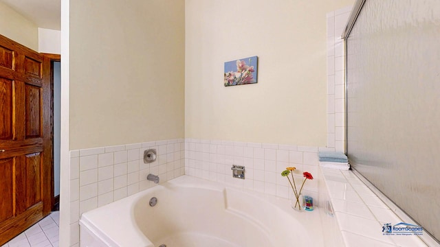 bathroom with a bath and tile patterned flooring