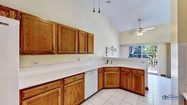 kitchen featuring white appliances, a sink, a ceiling fan, a peninsula, and brown cabinets