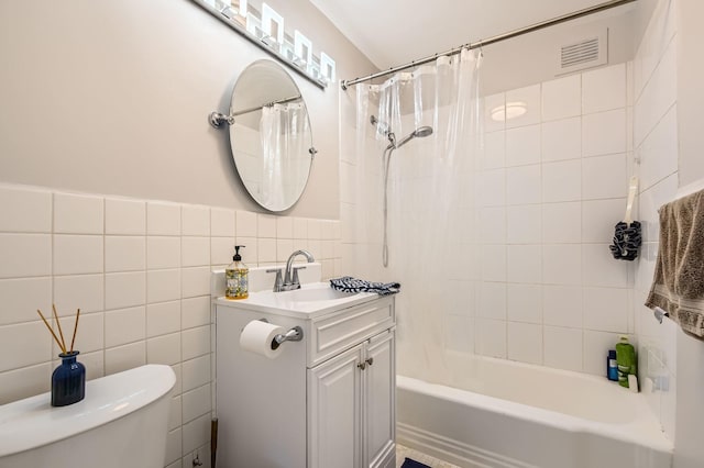 6301 N Sheridan Rd Unit 10F, Chicago, IL 60660 - full bathroom featuring tile walls, toilet, vanity, visible vents, and shower / tub combo with curtain