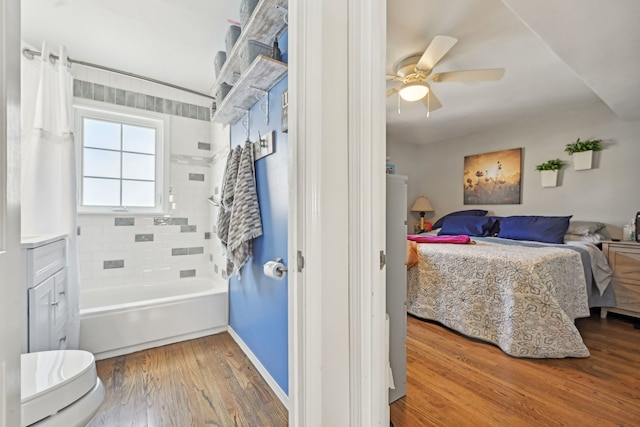 bedroom with a ceiling fan and wood finished floors