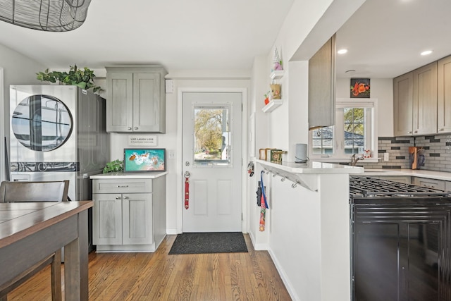 kitchen with a wealth of natural light, wood finished floors, recessed lighting, and light countertops