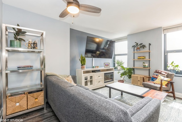 living area featuring wood finished floors, ceiling fan, and plenty of natural light