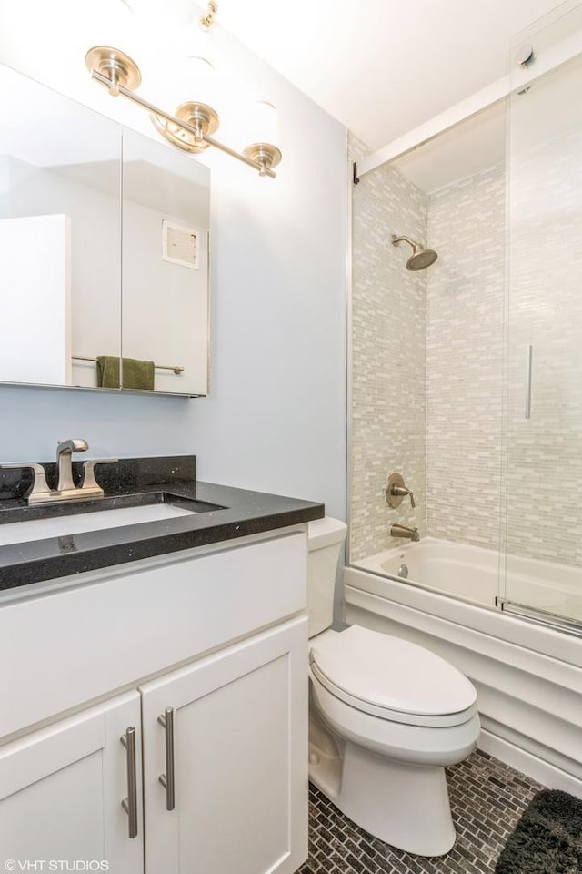 full bathroom featuring toilet, tile patterned floors, combined bath / shower with glass door, and vanity
