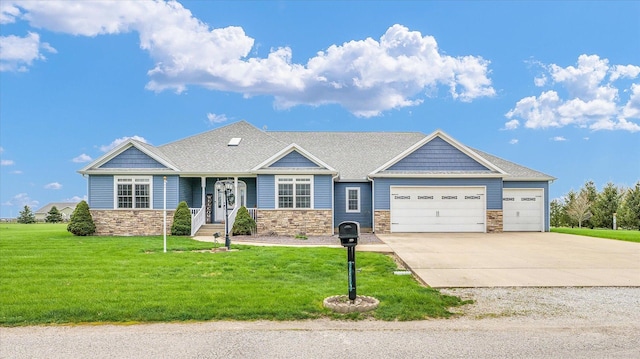 craftsman house with stone siding, an attached garage, a front yard, and concrete driveway