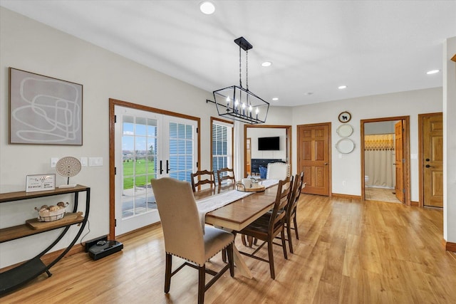 dining room with light wood-style floors, an inviting chandelier, french doors, baseboards, and recessed lighting