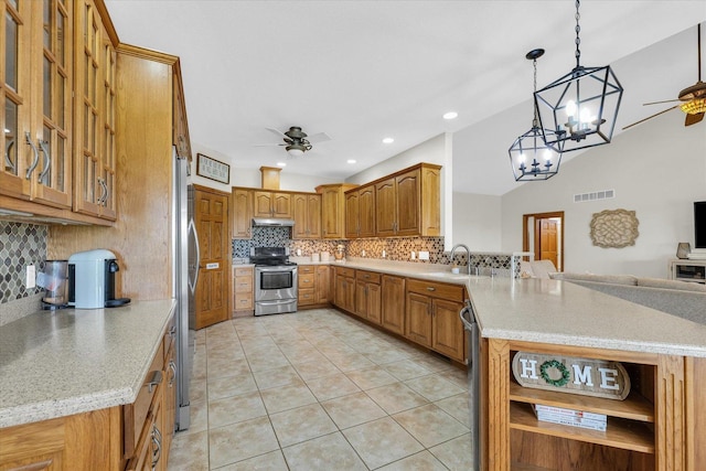 kitchen with backsplash, a peninsula, stainless steel appliances, and ceiling fan with notable chandelier