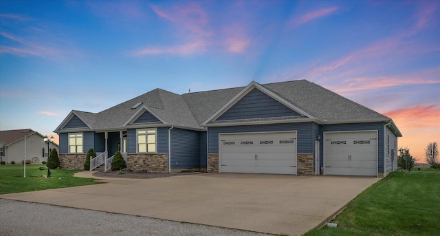 craftsman-style home with roof with shingles, stone siding, concrete driveway, a garage, and a lawn