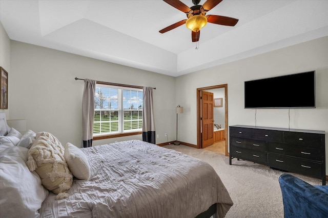 bedroom featuring ensuite bath, ceiling fan, light carpet, and baseboards