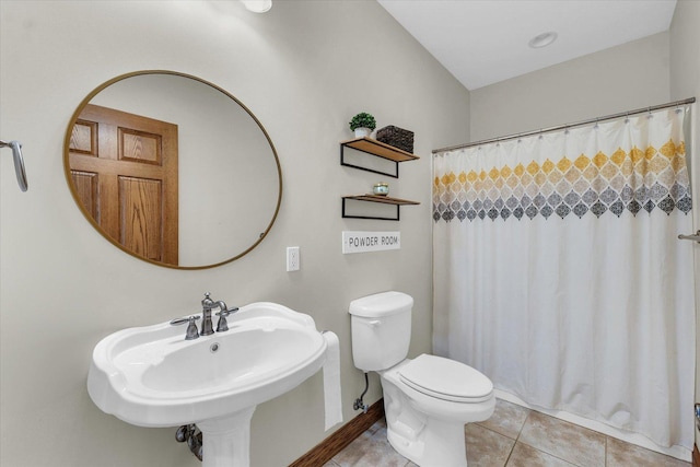 bathroom with tile patterned floors, a sink, a shower with shower curtain, and toilet