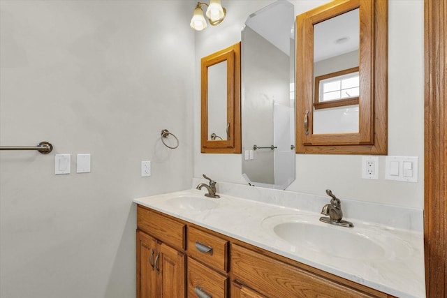 bathroom featuring a sink and double vanity