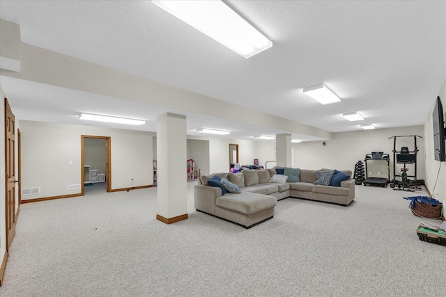 carpeted living room with visible vents and baseboards