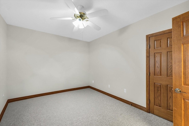 spare room featuring ceiling fan, carpet floors, and baseboards