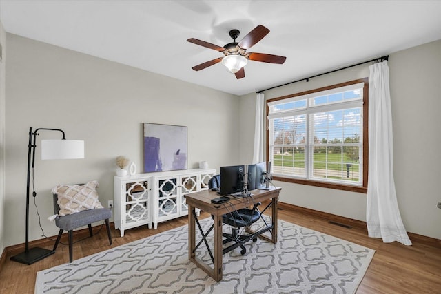 office featuring ceiling fan, baseboards, and wood finished floors