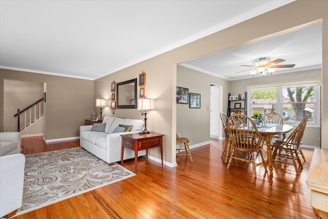 1088 Alameda Dr, Aurora, IL 60506 - living area featuring light wood finished floors, a ceiling fan, ornamental molding, and stairs